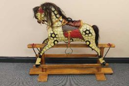 An early twentieth century painted wooden rocking horse, height 108 cm.   CONDITION REPORT:  Some