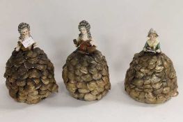 A set of three early twentieth century porcelain topped table lamps modelled as Ladies wearing shell