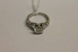 An 18ct white gold diamond ring, approximately 1.8ct, set with baguette and round-cut diamond