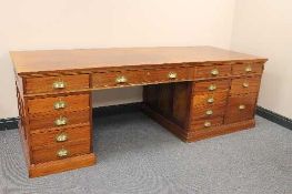 An early twentieth century mahogany pedestal desk, with plate glass top, width 229 cm.   CONDITION