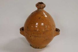 An eighteenth century glazed pottery bottle, height 22 cm.   CONDITION REPORT:  Incised initial '