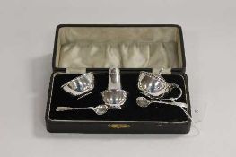 A silver three piece cruet set, cased.   CONDITION REPORT:  Good condition, dated Birmingham 1940/