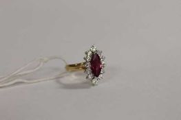 An 18ct gold marquise ruby and diamond cluster ring.   CONDITION REPORT:  Good condition.