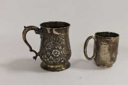 An early ninteenth century silver embossed tankard, together with a silver christening mug. (2)