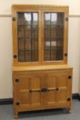An oak glazed bookcase by Robert 'Mouseman' Thompson of Kilburn, width 92 cm.   CONDITION REPORT: