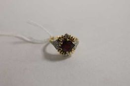 A ruby ring set with six diamonds.   CONDITION REPORT:  Good condition, mounted in white metal,