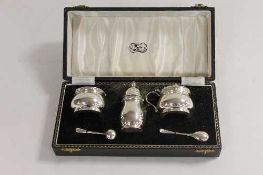 A silver three piece silver cruet set, retailed by Reids of Newcastle upon Tyne, cased.