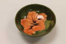A Moorcroft shallow dish with tubelined amaryllis pattern, diameter 11.5 cm.    CONDITION REPORT: