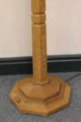 A carved oak standard lamp by Robert 'Mouseman' Thompson of Kilburn, height 36.5 cm.   CONDITION