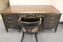 An early twentieth century stained pine pedestal desk, width 182 cm, together with desk chair. (2)