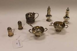 Two pairs of silver pepperettes, together with a pair of silver salts with spoons and a silver