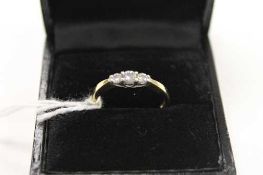An 18ct gold three stone diamond ring, approximately 0.25ct.   CONDITION REPORT:  Good condition.