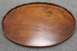 A nineteenth century inlaid mahogany oval butler's tray, width 70 cm.   CONDITION REPORT:  A small
