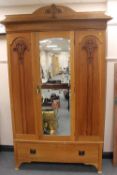 An Edwardian walnut mirror door wardrobe fitted with a drawer, width 136 cm.   CONDITION REPORT: