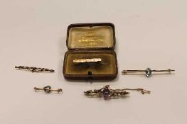 A 9ct gold bar brooch set with an amethyst and seed pearls, together with four other vintage bar