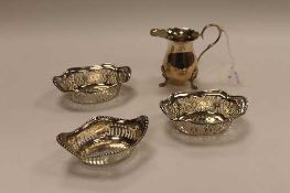 A silver cream jug, Birmingham 1972, together with three silver dishes with pierced decoration,