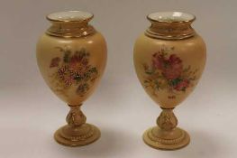 A pair of Royal Worcester blush ivory gilded urns, shape 2260, height 14.5 cm.  (2)   CONDITION