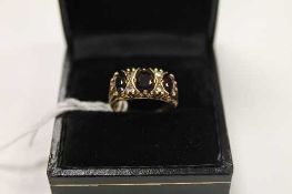 An early twentieth century 9ct gold ring set with three garnets.    CONDITION REPORT:  Good