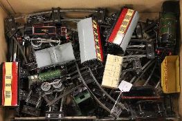 A collection of Hornby O'gauge tin plated train items including three engines, rolling stock and
