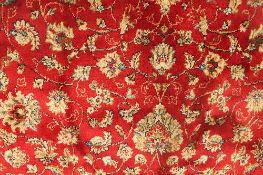 A Kashmir fringed rug with floral borders on red ground, 135 cm x 200 cm.   CONDITION REPORT:
