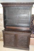 A late Victorian carved oak bookcase, width 153 cm.   CONDITION REPORT:  Good time aged condition