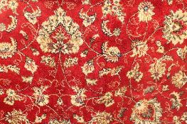 A Kashmir fringed rug with floral borders on red ground, 122 cm x 244 cm.   CONDITION REPORT: