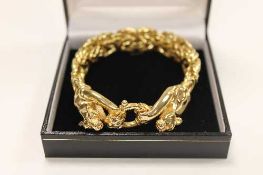 A 9ct gold link bracelet with leopard terminals, 31.1g.   CONDITION REPORT:  Good condition.