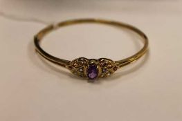 A 9ct gold bangle set with gemstones, 10.5g.   CONDITION REPORT:  Good condition.