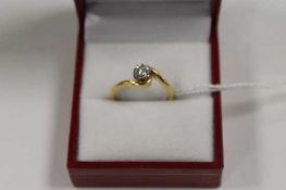 An 18ct gold diamond solitaire ring on twist setting.   CONDITION REPORT:  Good condition.