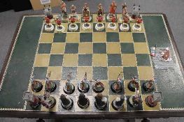 A thirty two piece Tower of London 900th anniversary chess set, on oak refectory board table