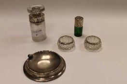 A green glass flask with silver top, together with a silver ashtray, a pair of silver rimmed salts