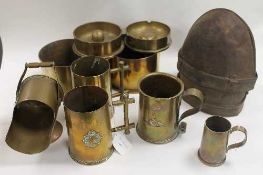 A collection of WW I brass trench art including tankards, scuttle and shells, together with a pair