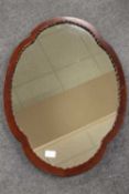 An Edwardian mahogany shaped mirror, width 53 cm.   CONDITION REPORT:  Good condition.
