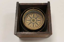 An early twentieth century marine compass, cased in oak.     CONDITION REPORT:  Good condition.