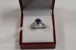 An 18ct white gold diamond and sapphire cluster ring.   CONDITION REPORT:  Good condition.