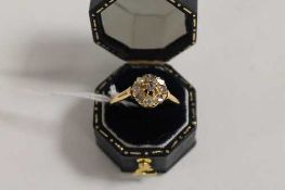 An Edwardian diamond cluster ring. CONDITION REPORT: Fair condition, the yellow metal shank unmarked