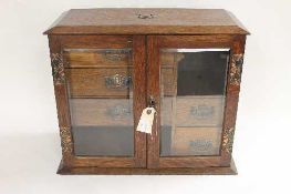 A late Victorian oak smoker's cabinet, width 48 cm. CONDITION REPORT: Fair condition, requires