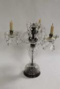 A set of eight crystal table candelabra, together with a matching wall light. (9) CONDITION