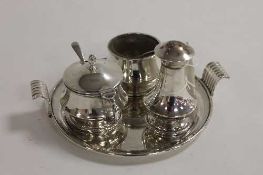 A silver three piece condiment set on silver tray. (4) CONDITION REPORT: Good condition, with silver