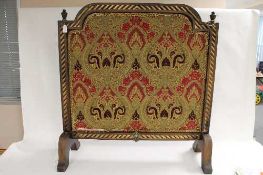 A Victorian style embroidered fire screen, height 102 cm. CONDITION REPORT: Fair condition, some age