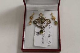 An Edwardian 9ct gold seed pearl and peridot pendant with matching earrings. (3) CONDITION REPORT: