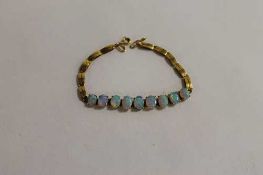 An opal bracelet, mounted in yellow metal. CONDITION REPORT: Good condition.