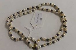 A double-strand of two-tone cultured pearls on 9ct gold clasp. CONDITION REPORT: Good condition.