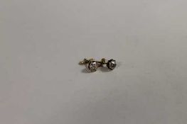 A pair of old-cut diamond stud earrings, approximately 0.25ct each. CONDITION REPORT: Good