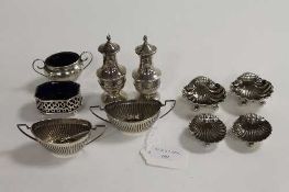 Two pairs of silver shell salts, together with six other small silver salts and pepper pots. (10)