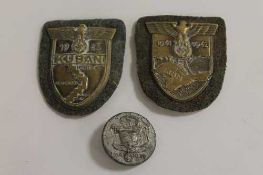 Two early Third Reich Kuban and Krim campaign shields, together with a 1938 Labour Day badge.. (3)