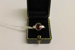 An 18ct white gold ruby ring, set with two diamonds. CONDITION REPORT: Good condition.