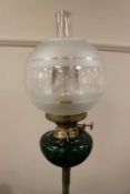 A late nineteenth century brass telescopic oil lamp with green glass reservoir. CONDITION REPORT: