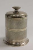 A silver cigarette dispenser with engine-turned sides, height 11.5 cm. CONDITION REPORT: Good