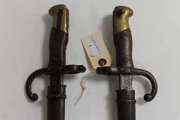 Two nineteenth century bayonets in scabbards. (2) CONDITION REPORT: One French and one German